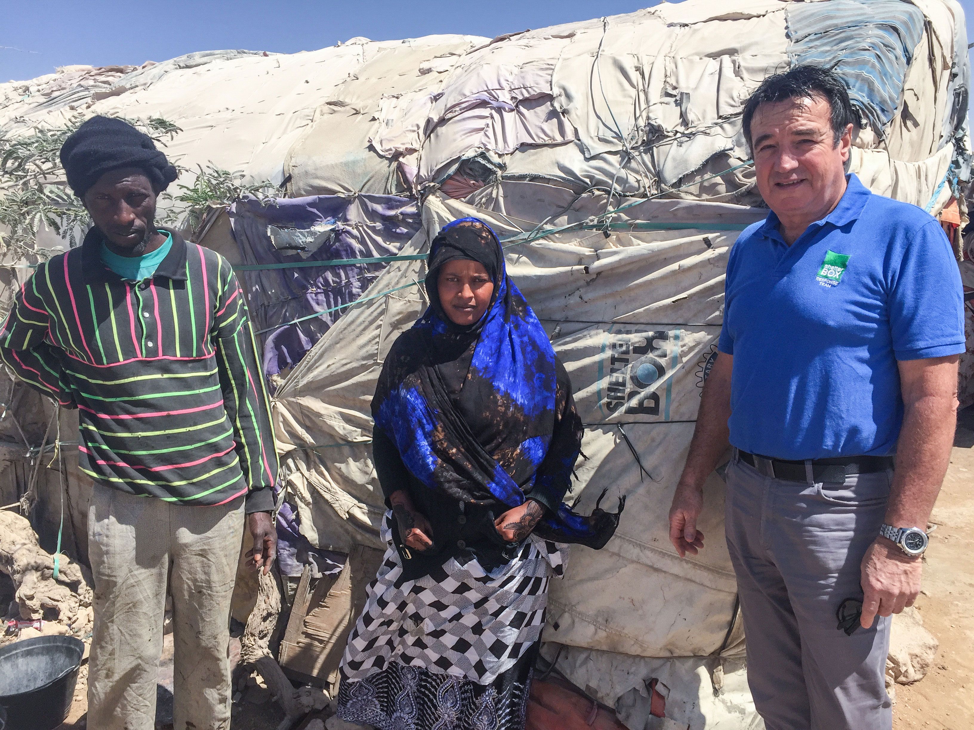 Muna Mohammed with 10 year old ShelterBox tent making up part of a much larger structure, her Café Prosperity.