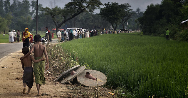 Bangladeshi people wait for aid