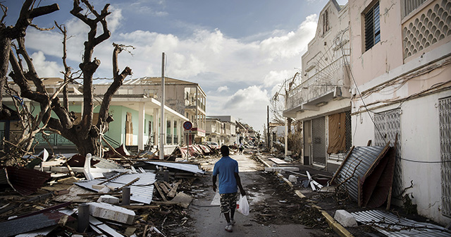 A man walks on a street covered in debris after hurricane Irma passed through the French island of Saint-Martin, near Marigot on September 8, 2017.