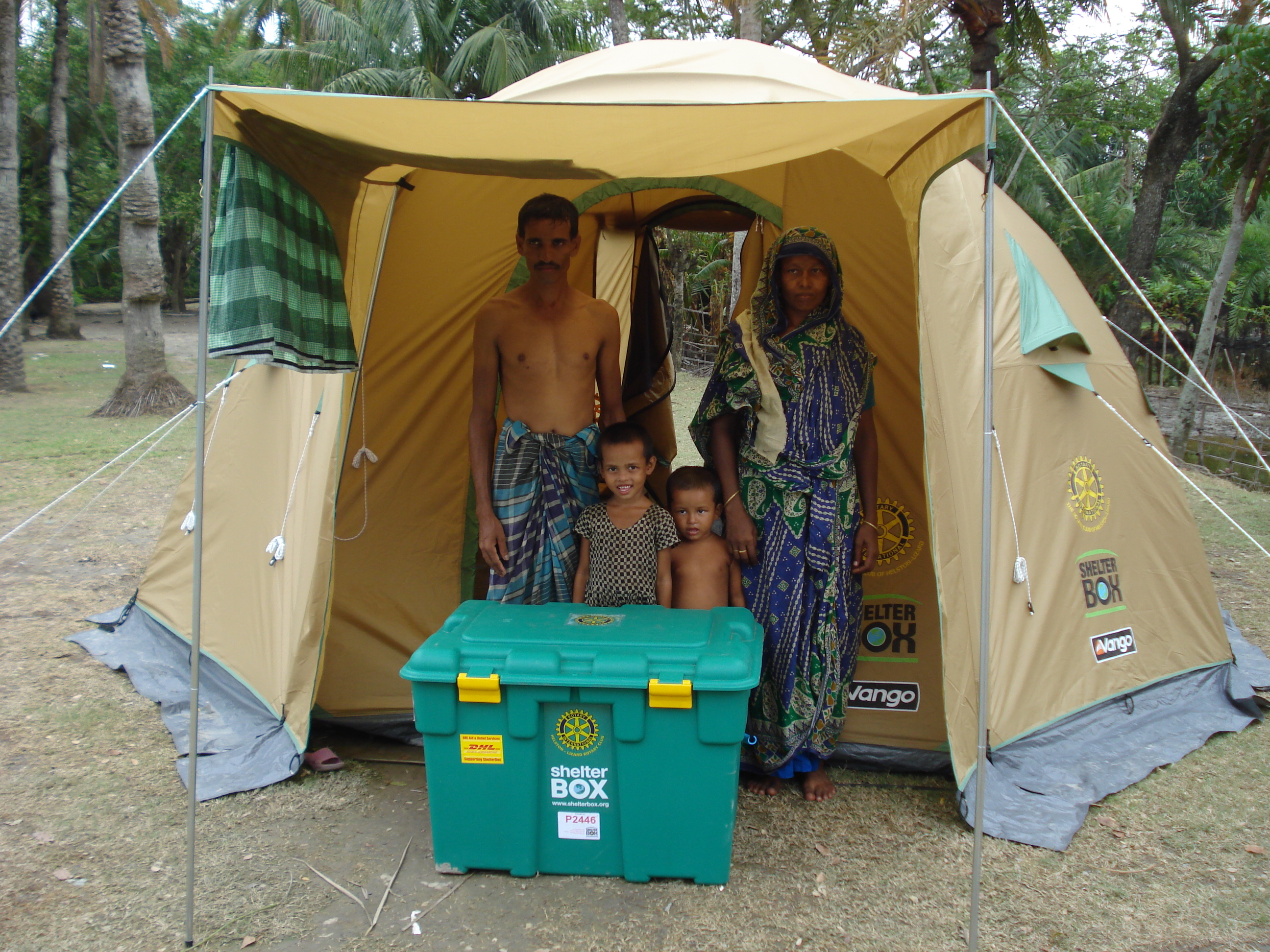 Family in golden ShelterBox tent