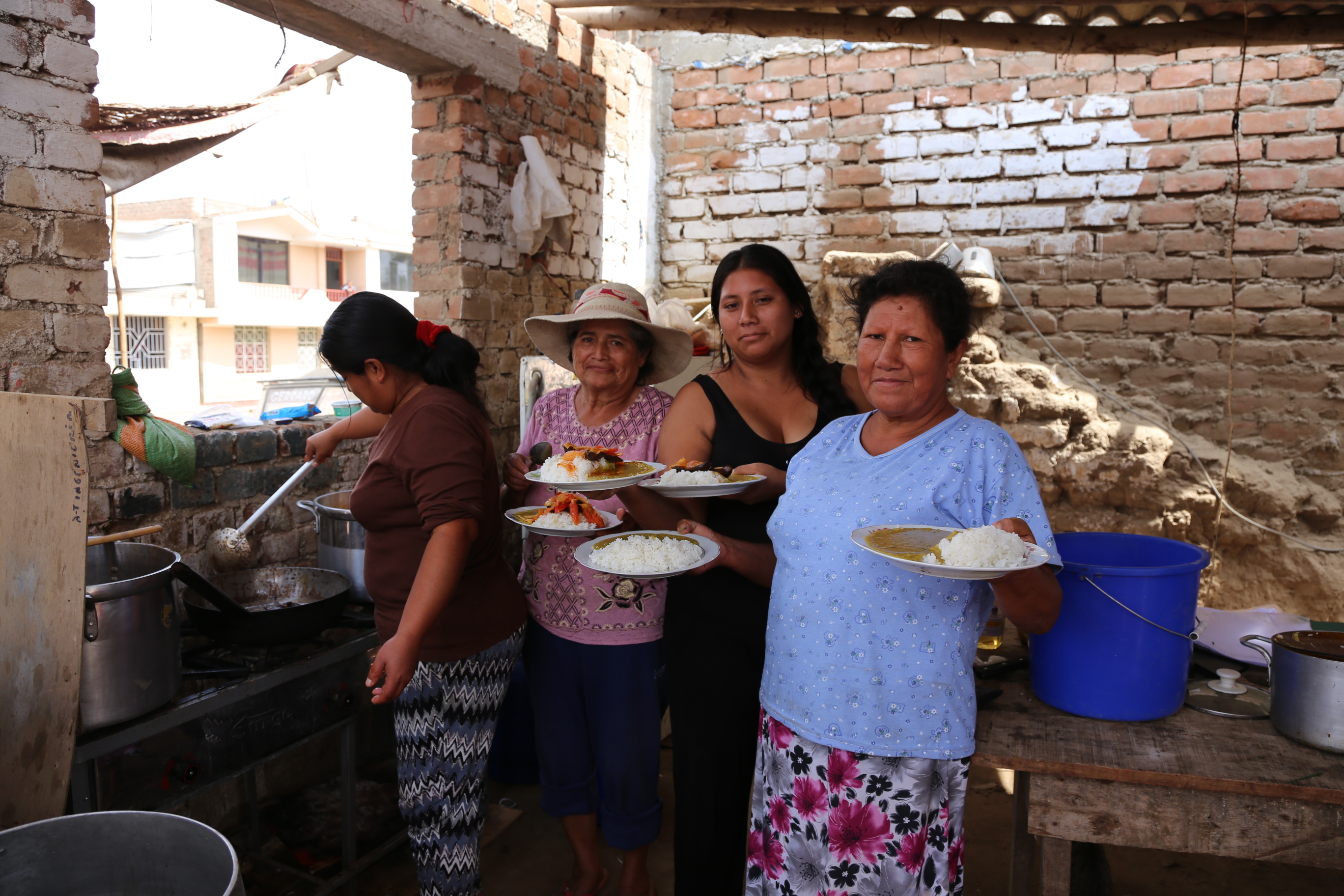 Yolanda and her friends showing their dishes
