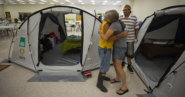 ShelterBox set up privacy tents in the American Legion Post 658 as they respond to the aftermath of Hurricane Harvey. Donald Koonce get a hug from friend Cindy Crow after moving into their 