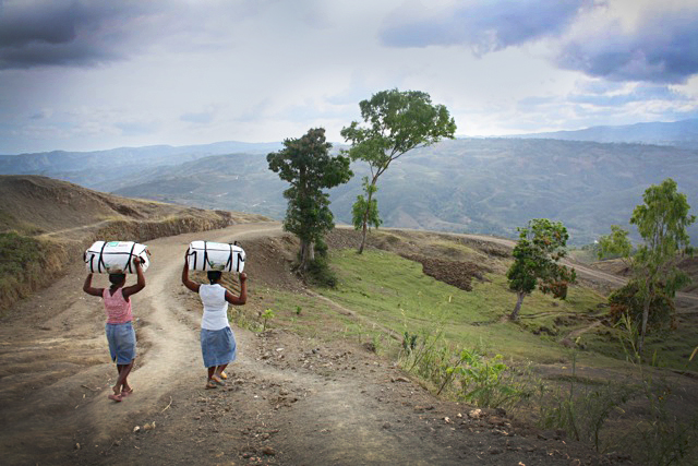 Women carrying tents