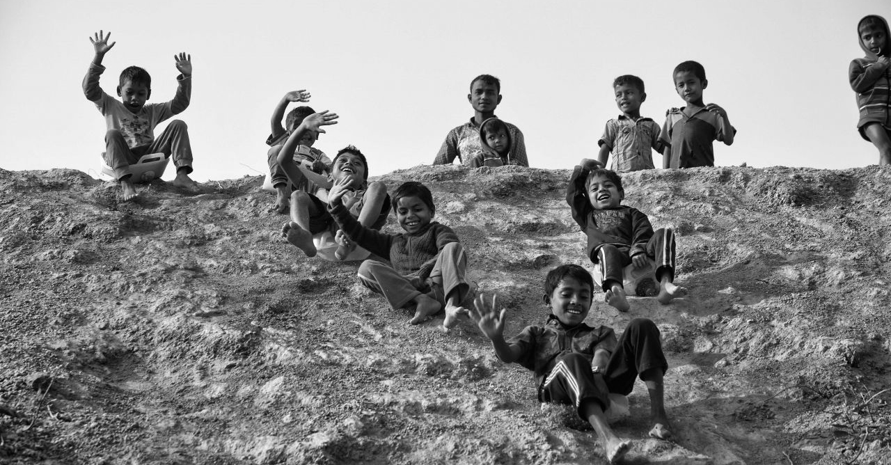 Children playing on a hill