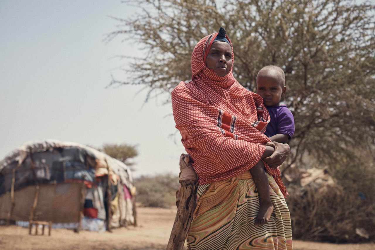 Woman with child photo by Olly Burn