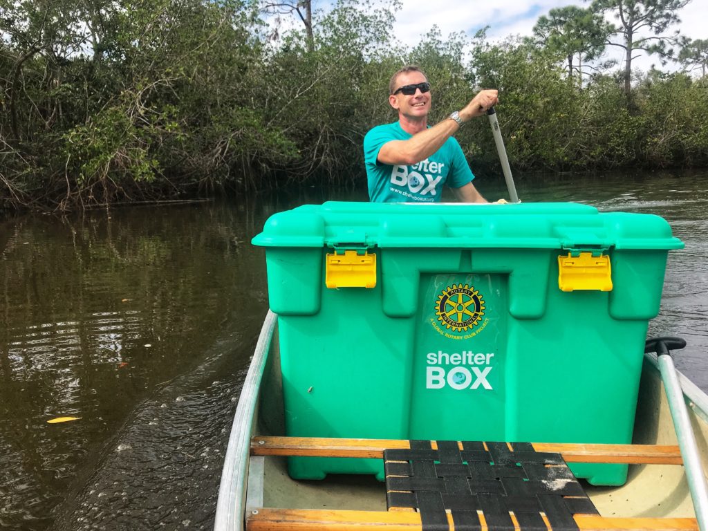 Erik paddling in canoe with his ShelterBox