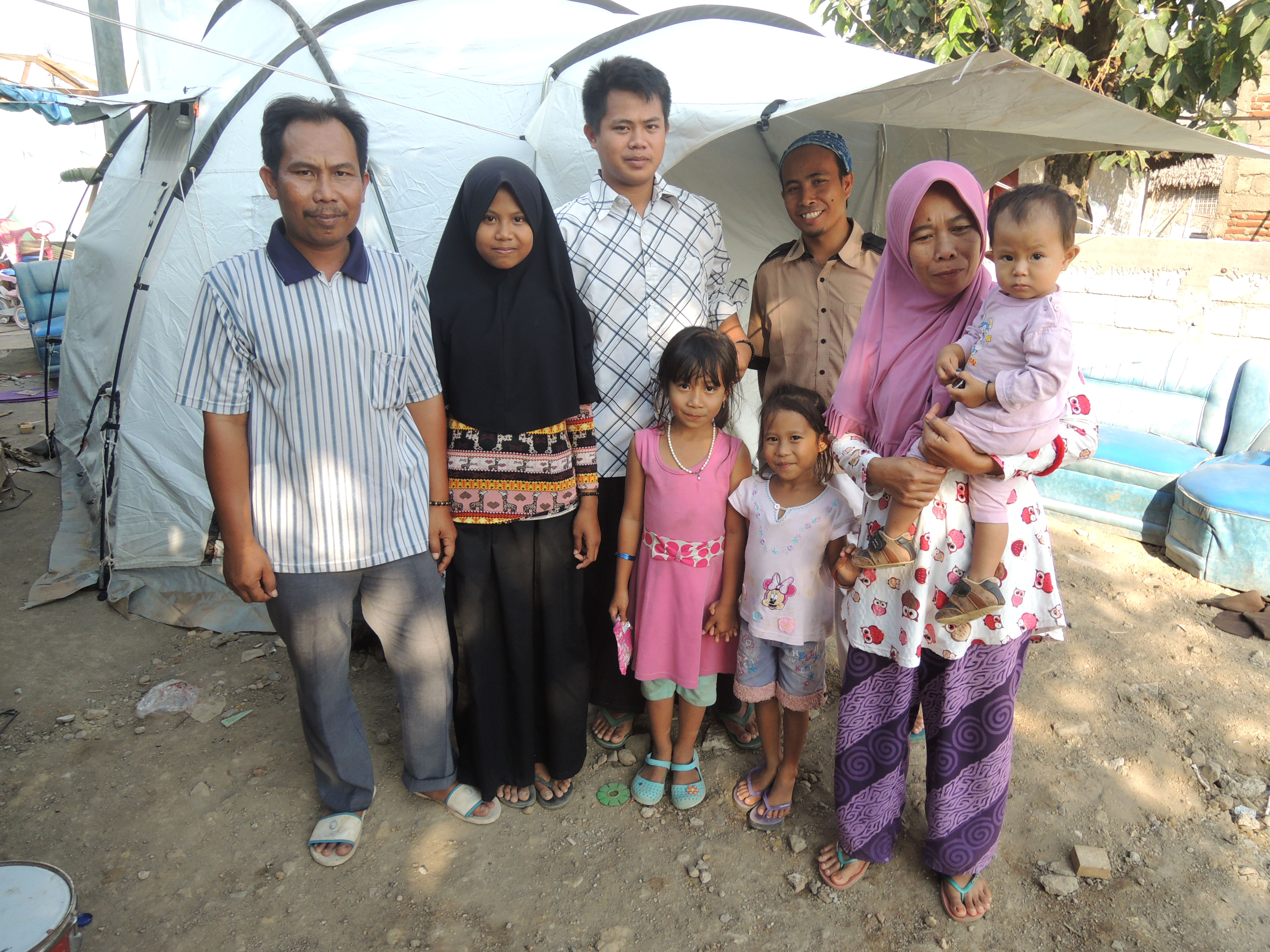 Ahmed and his children with their tent.