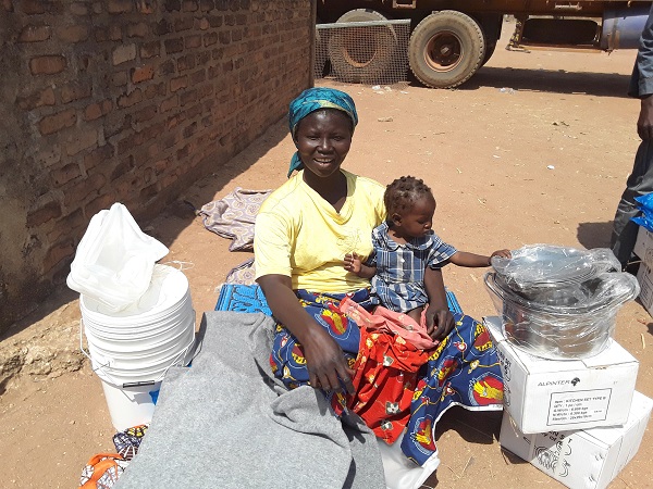 Mirielle and her child with their new supplies