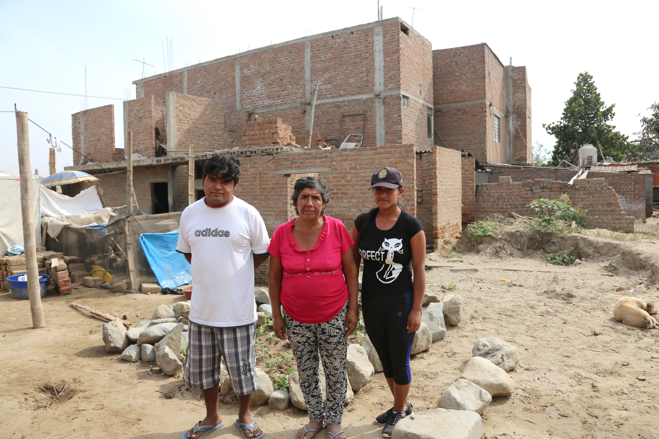 Julia and family on the site of where their home once stood