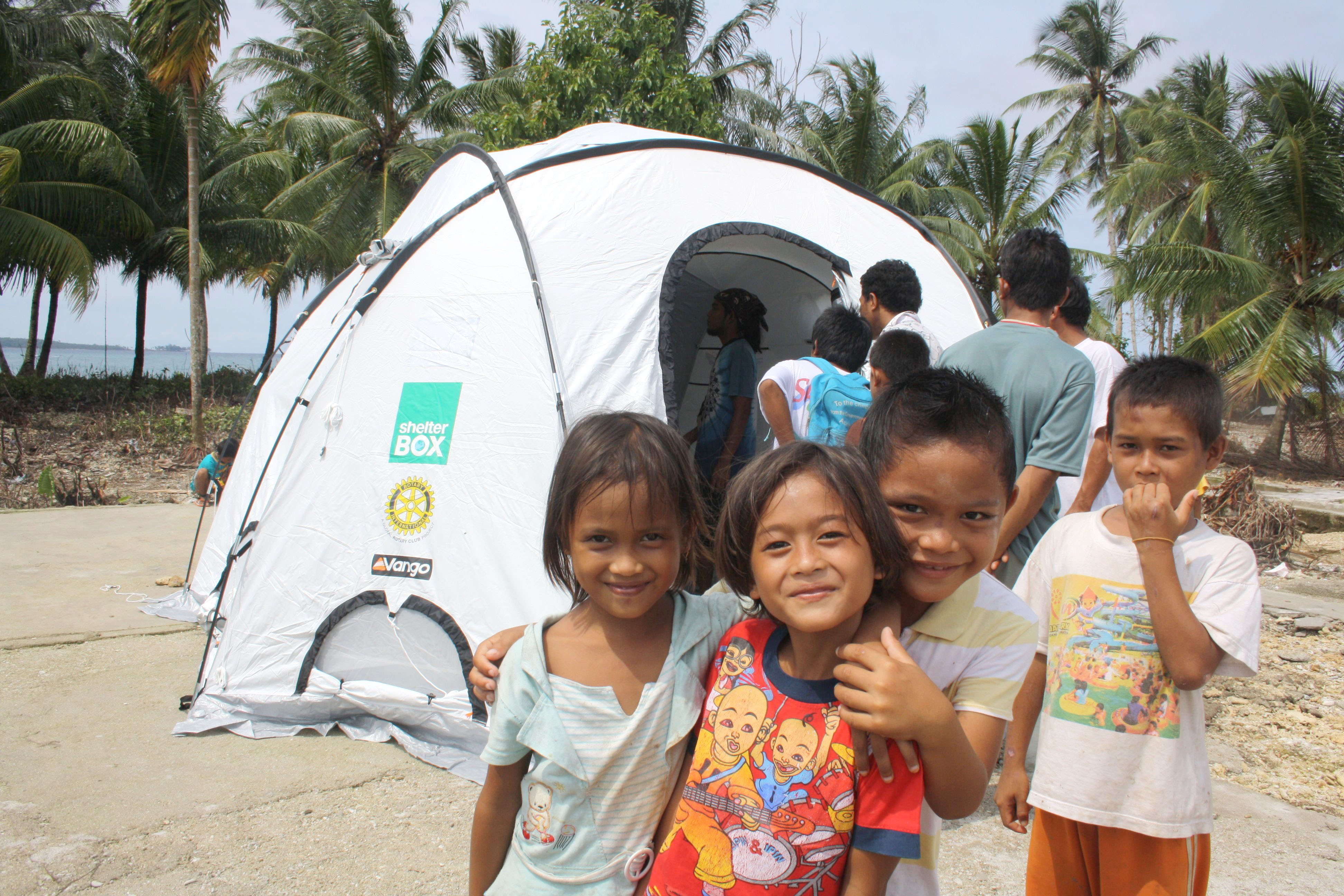 Children on the beach outside tent