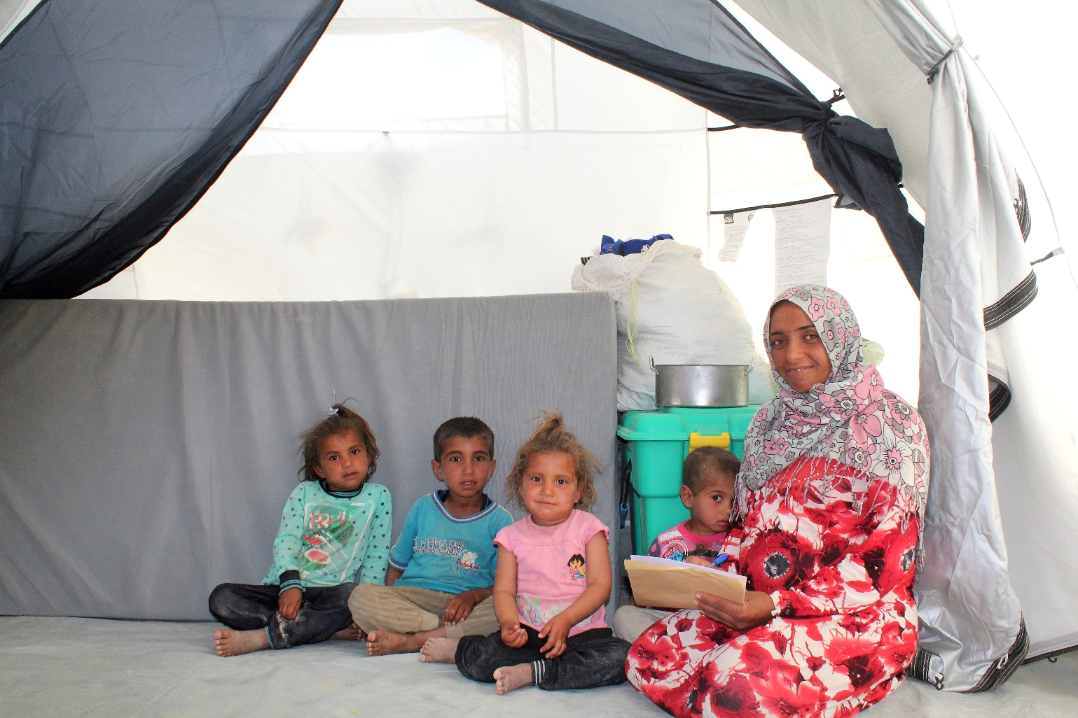 Ali and her 4 children in their tent