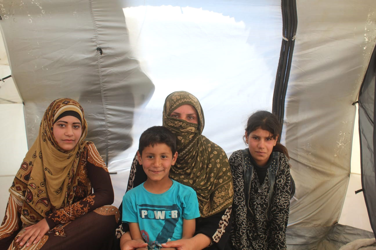 Asmahan and her children inside their tent