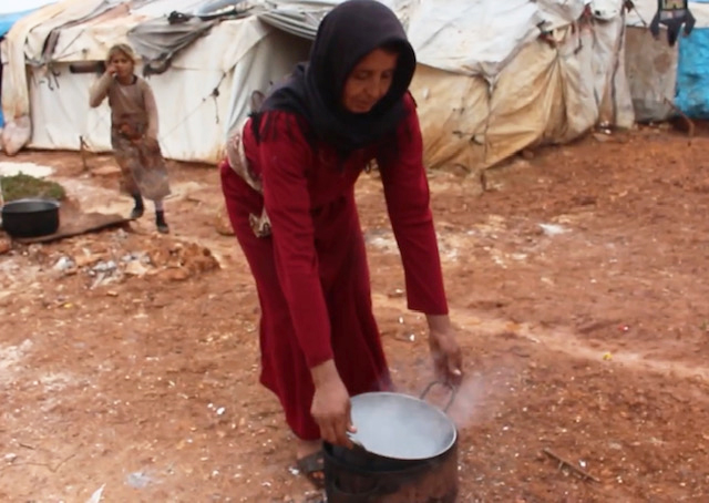 Ayman preparing to cook with boiling water outside