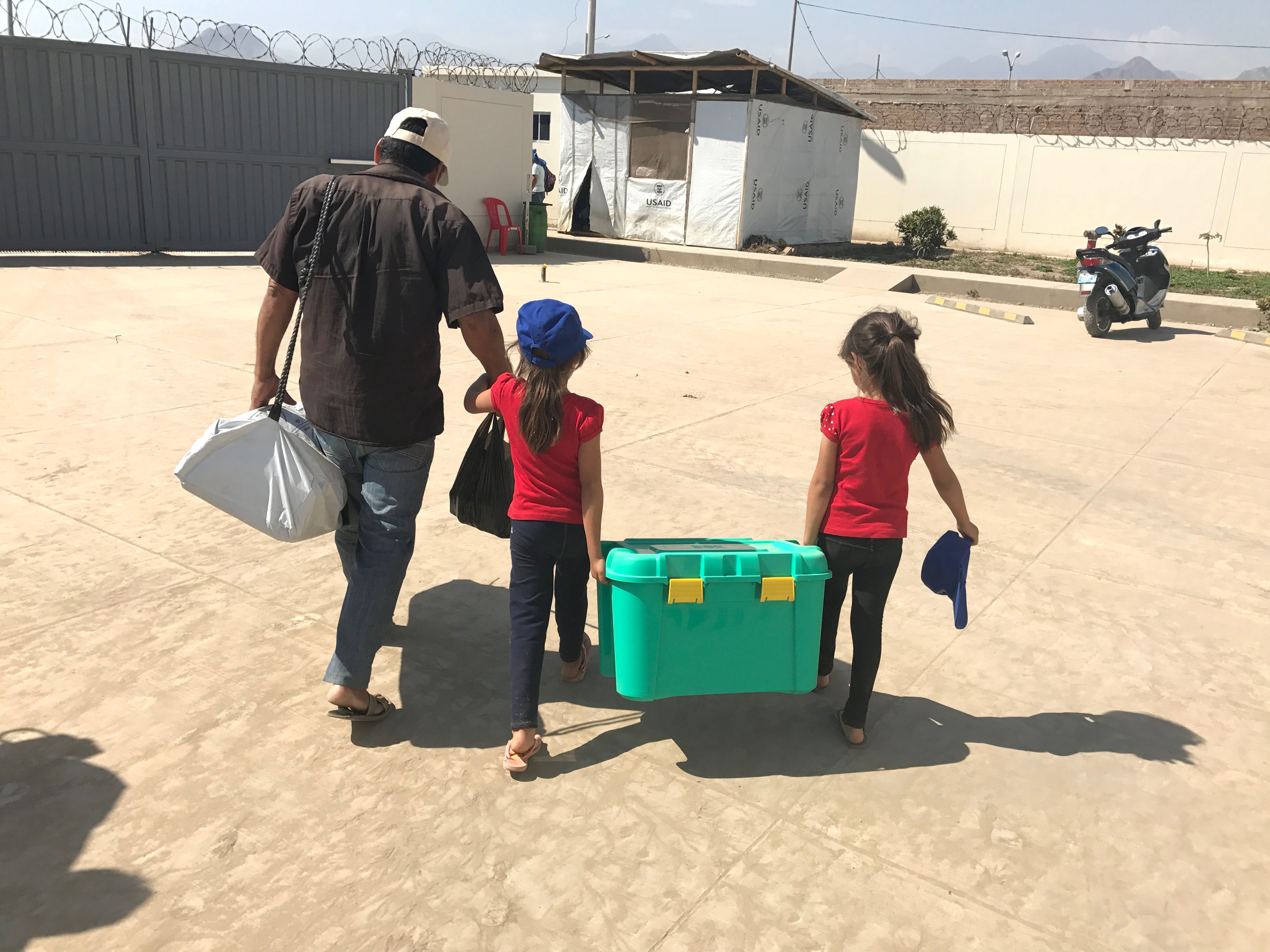 Carrying a shelterkit across the camp grounds