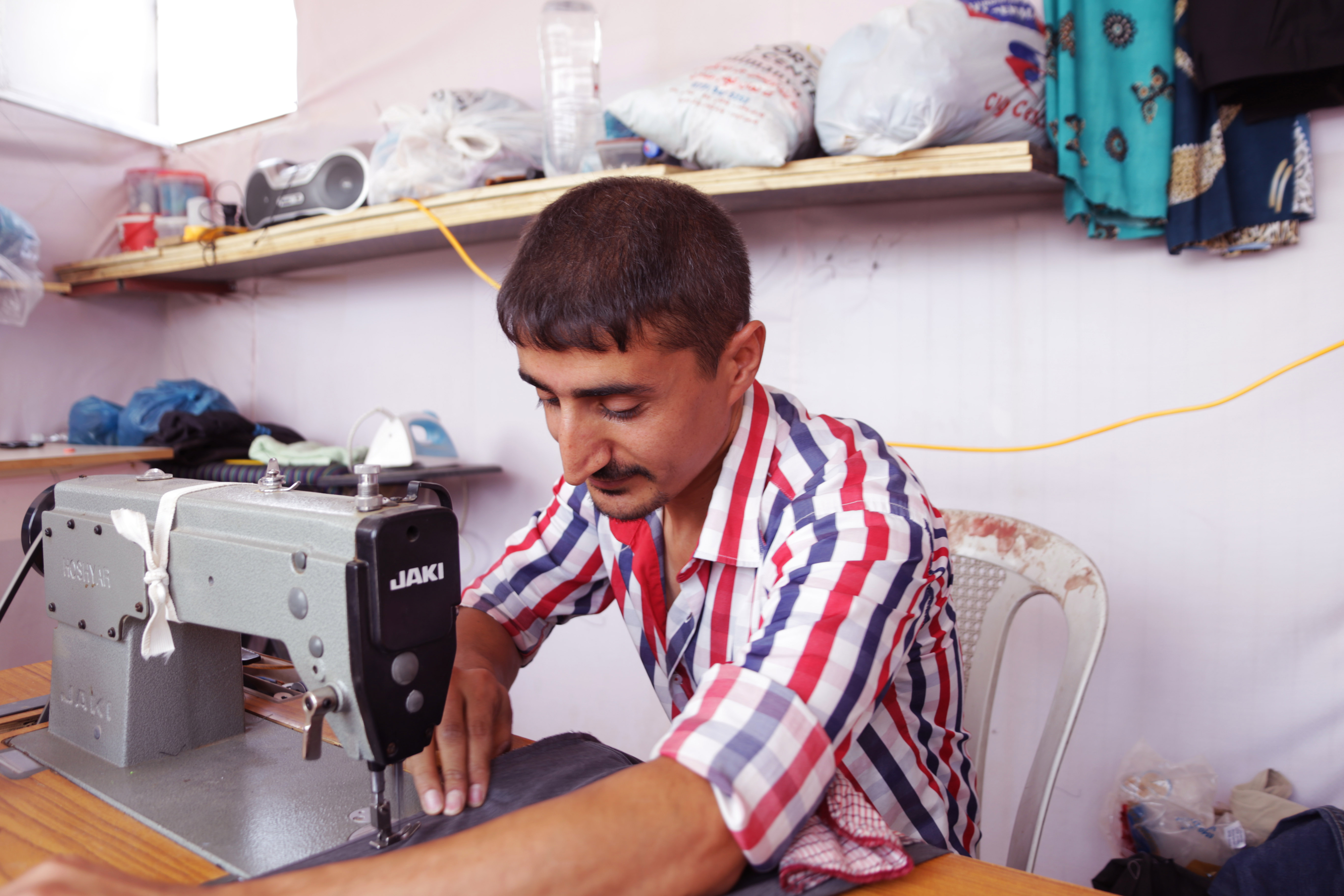 Hoshang hard at work with his sewing machine