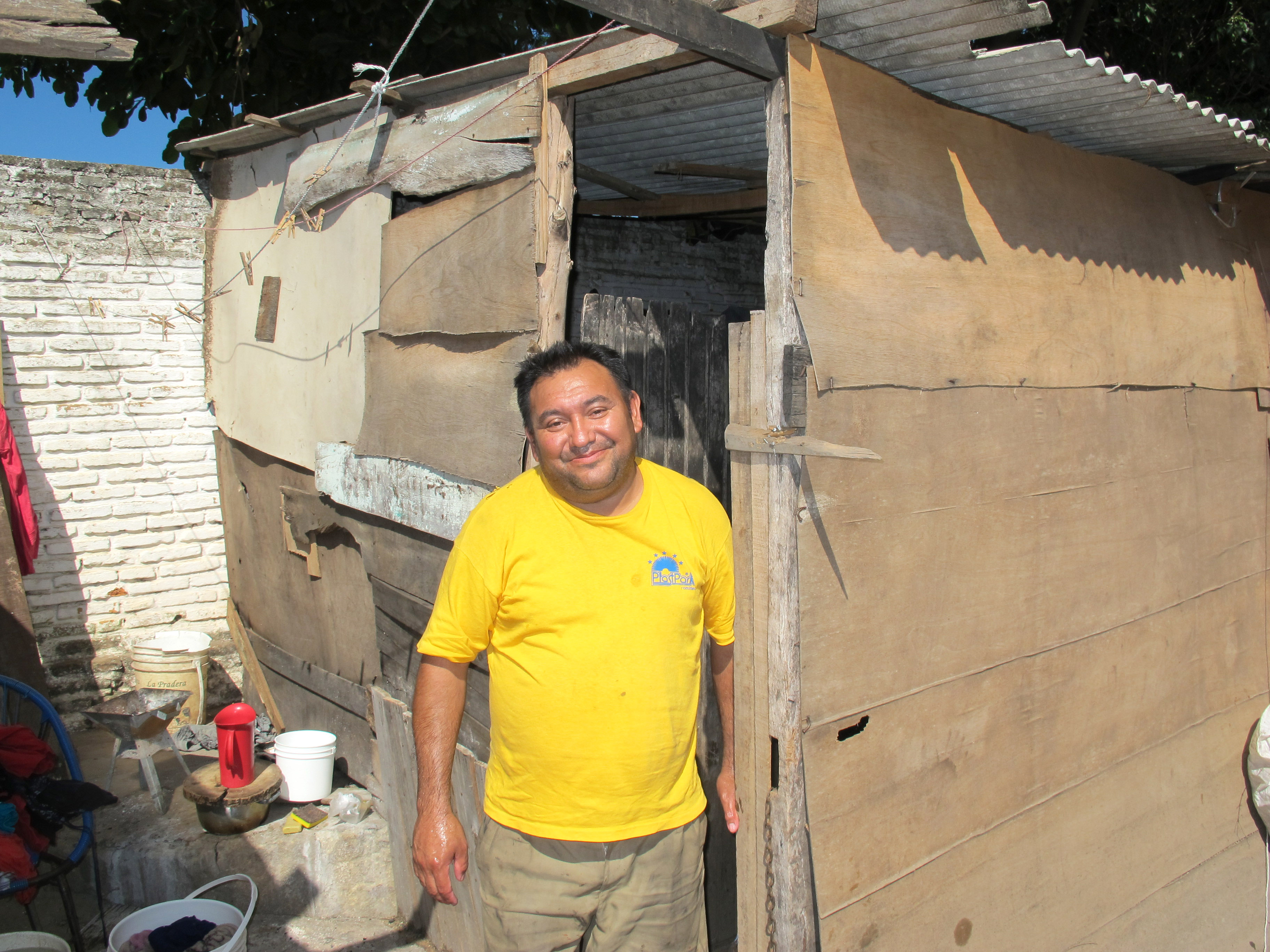 Ramon smiling in sun outside his home