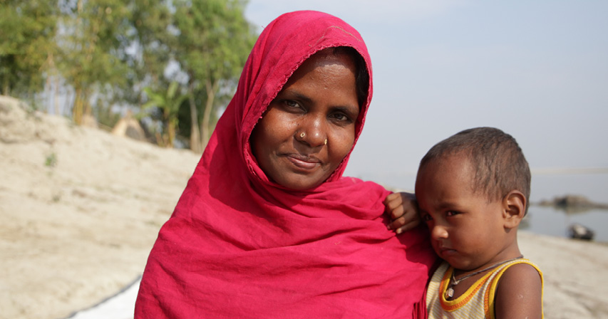 Behula and her youngest son along the river.