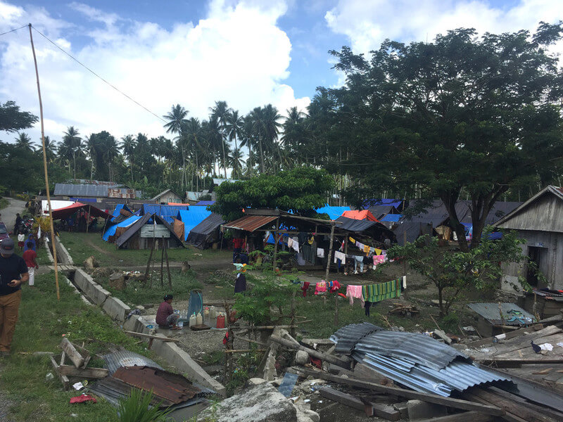 Roofs and other debris scattered across the landscape