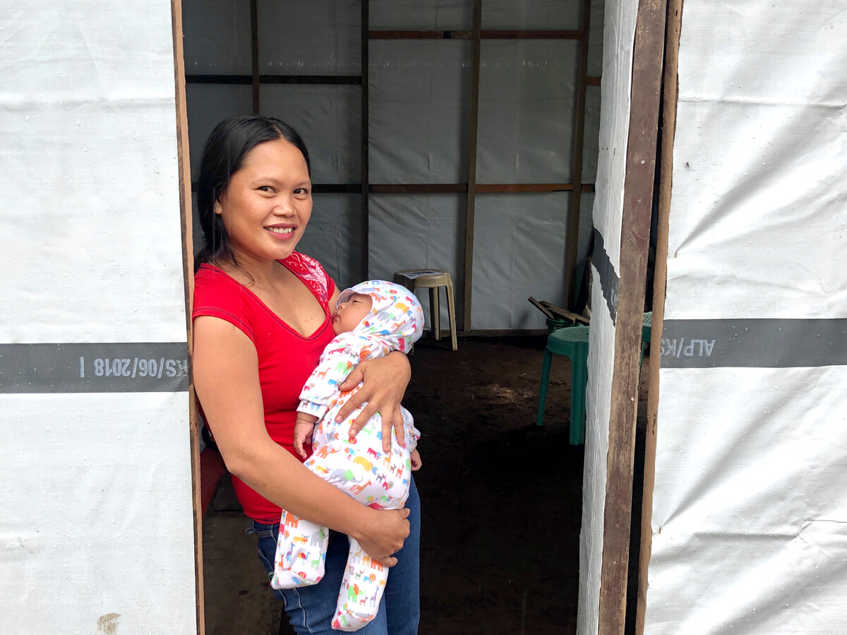 Nellie and her daughter in structure repaired with Shelter Kit materials