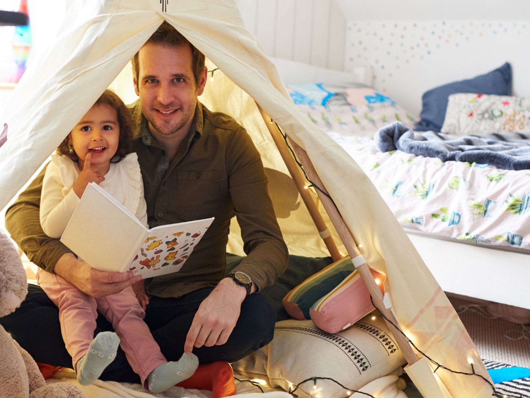 Father and daughter in a homemade fort