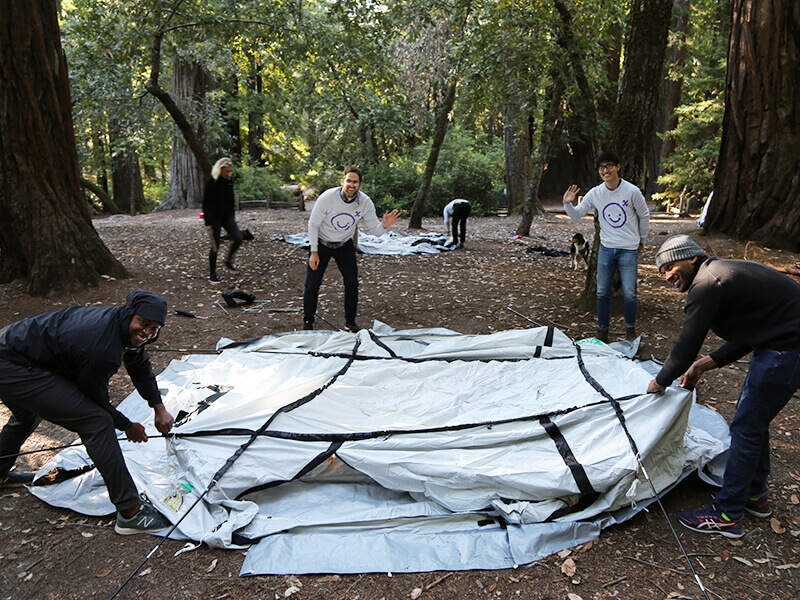 AirBnb team members setting up tent