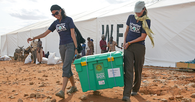 L-R Emily LoSavio (USA) and Rebecca Ridgeway (UK) carry the first of 1600 destined for Dolo Ado at the Haloweyn Refugee Camp, Somali Region, Ethiopia