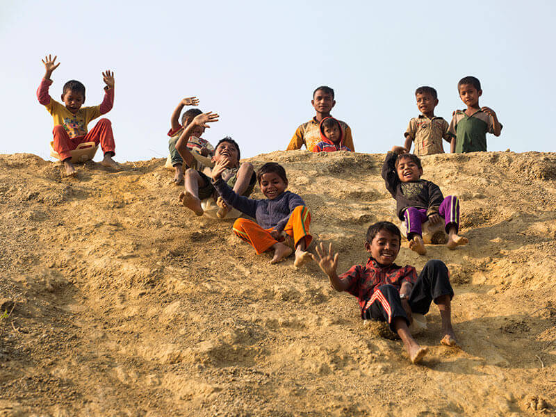 Children playing on a hill