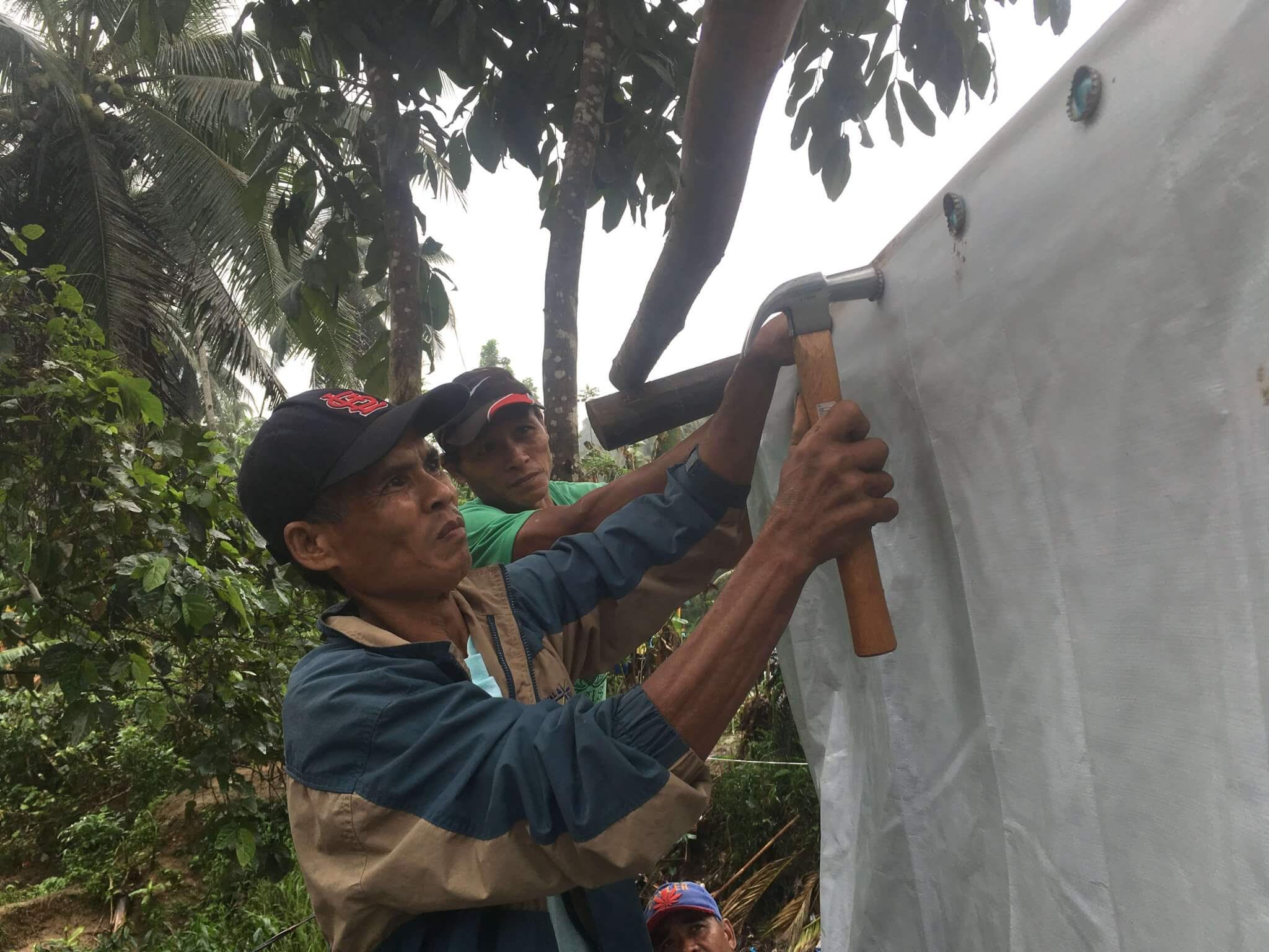Using shelter kit tools to secure a wall, Philippines