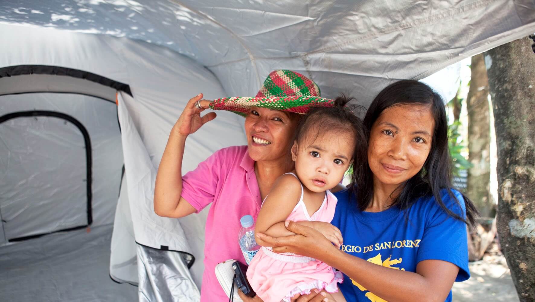 Ladies and a young child in their new tent