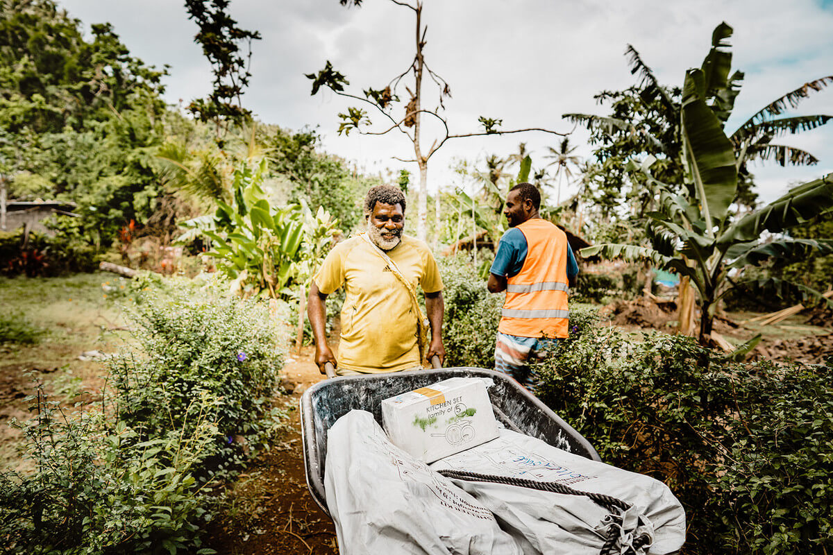 wheeling kits through the forest in Vanuatu