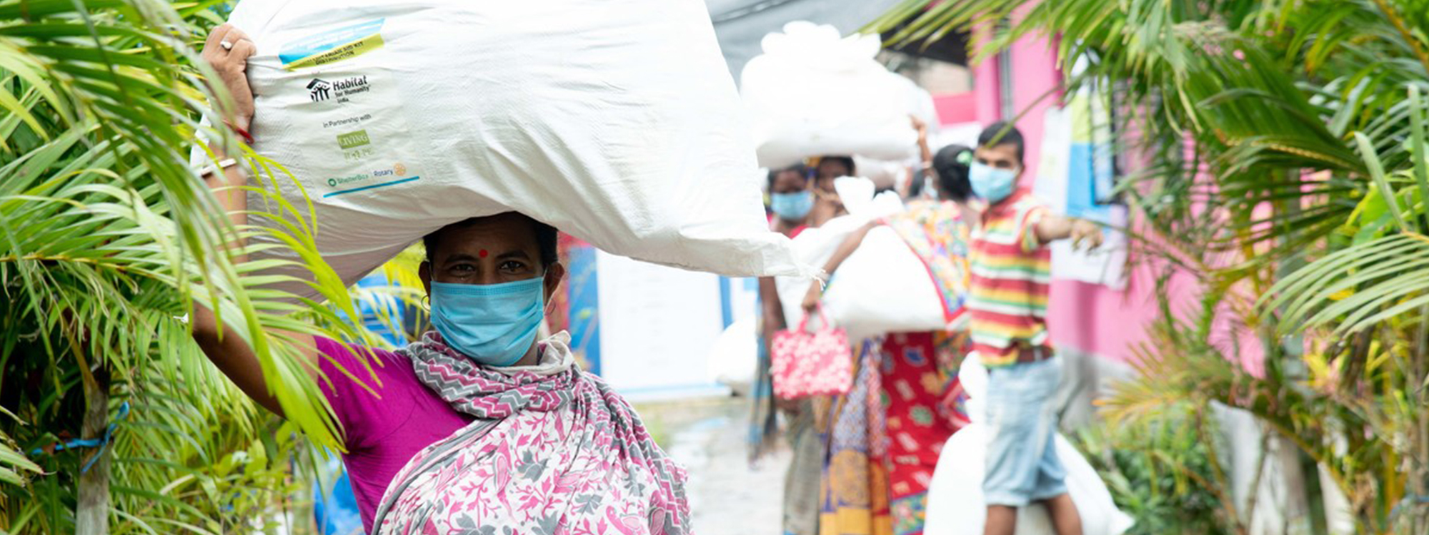 Woman with aid item after Cyclone Amphan