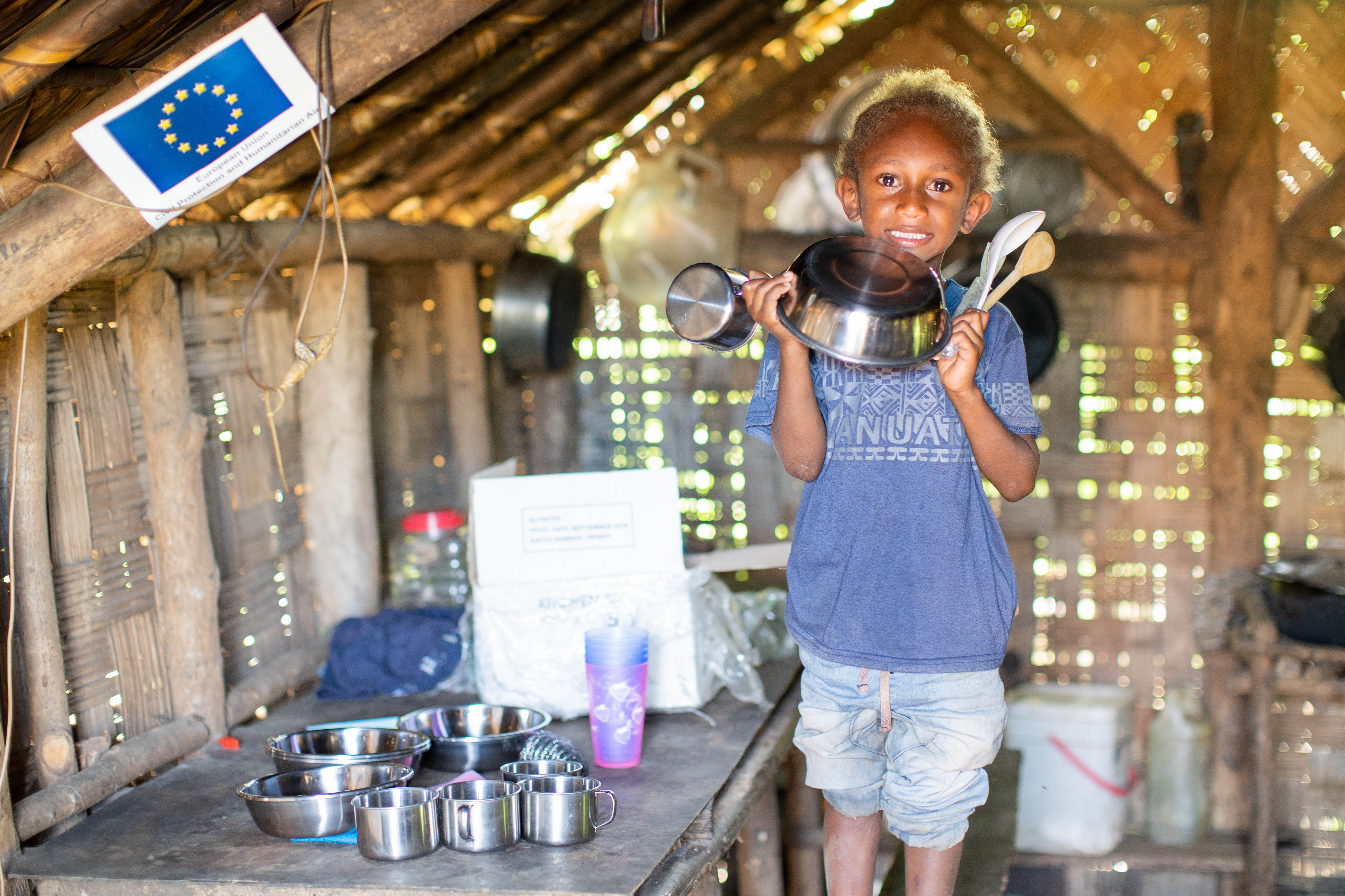 Shelley Melten and her son Locklin with their donated kitchen kit, Hotwota, South Pentcost. Shelley says her children always ask to use the 'disaster' cups and spoons that came as a part of the ktichen kit donated to the family.