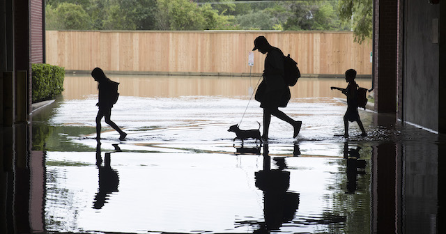 The Martinez family evacuates the apartment complex they live in near the Energy Corridor of west Houston, Texas where high water coming from the Addicks Reservoir is flooding the area after Hurricane Harvey