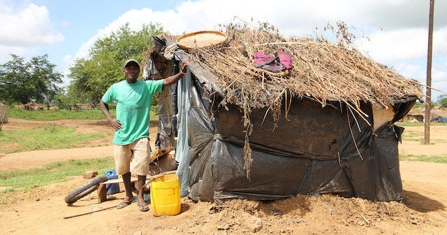 Malawian Man with the home he built