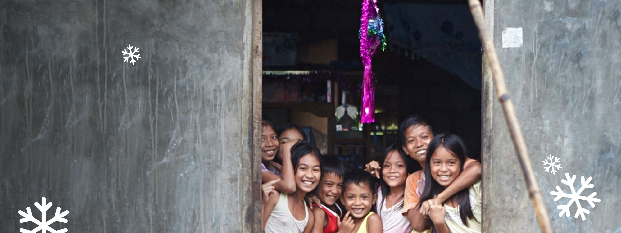 Children playing under a christmas tree in the philippines