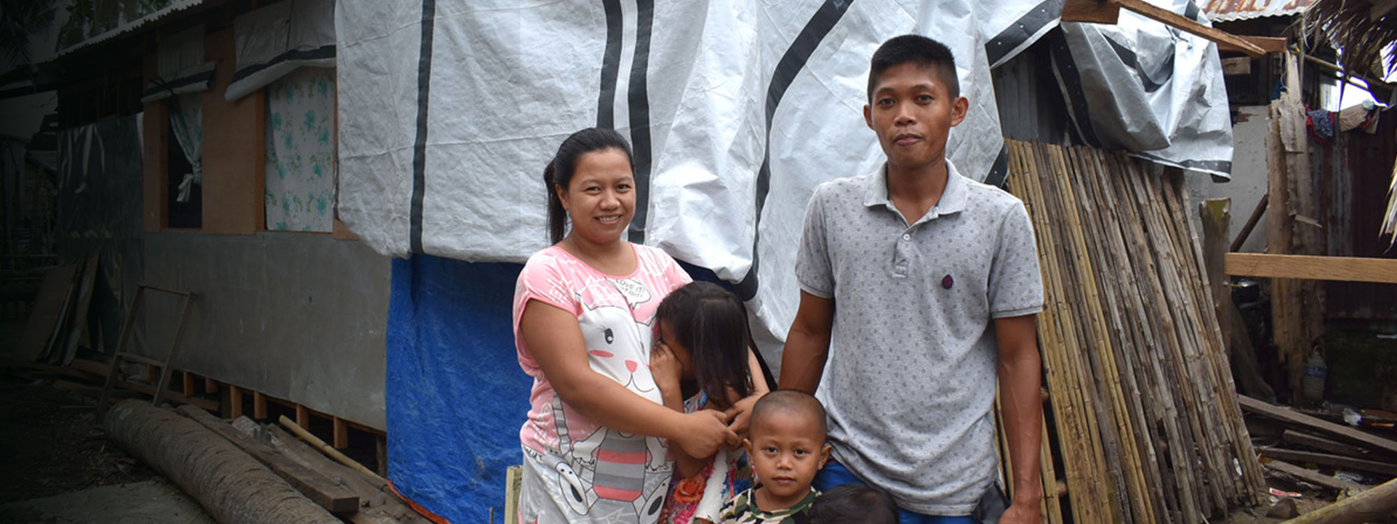 Nelcie and Family outside their home