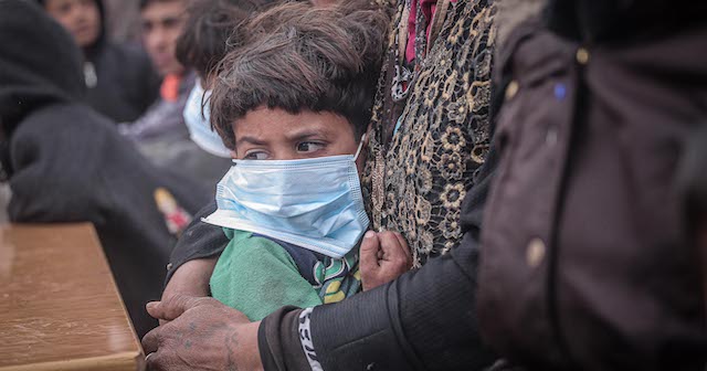 IDLIB, SYRIA - MARCH 18 : A child wears a mask as a preventive measure against coronavirus (Covid-19) as Idlib Health Directorate and Civil Defense Crews along with local charities carry out disinfection works at schools and tent cities in Idlib, Syria on March 18, 2020. (Photo by Muhammed Said/Anadolu Agency via Getty Images)