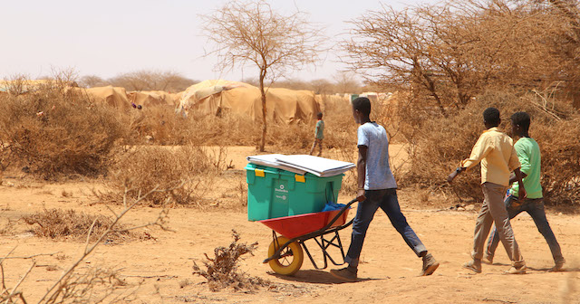 Family gets their aid by wheelbarrow after drought