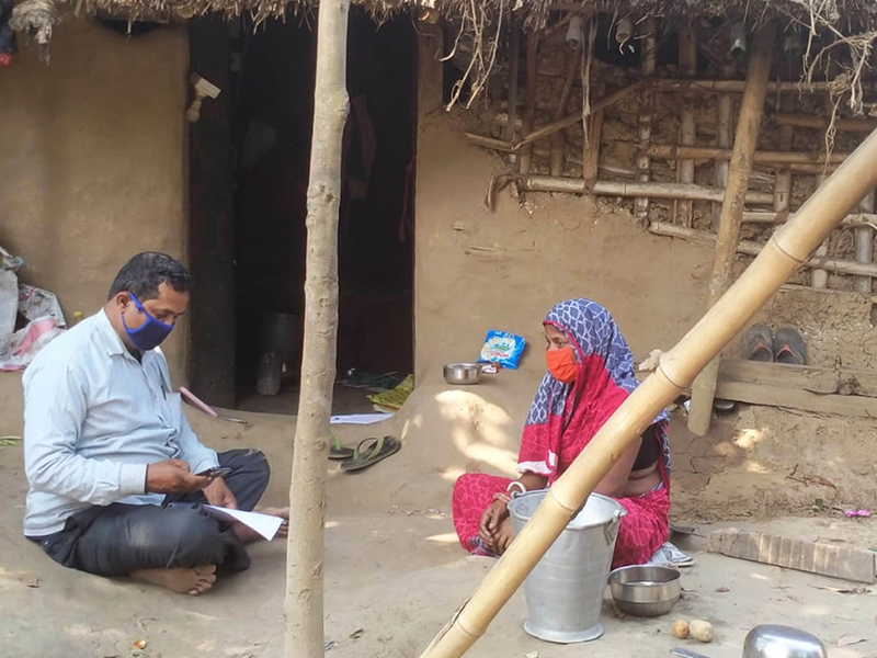 A Habitat for Humanity staff member conducting community consultations ahead of distributions.