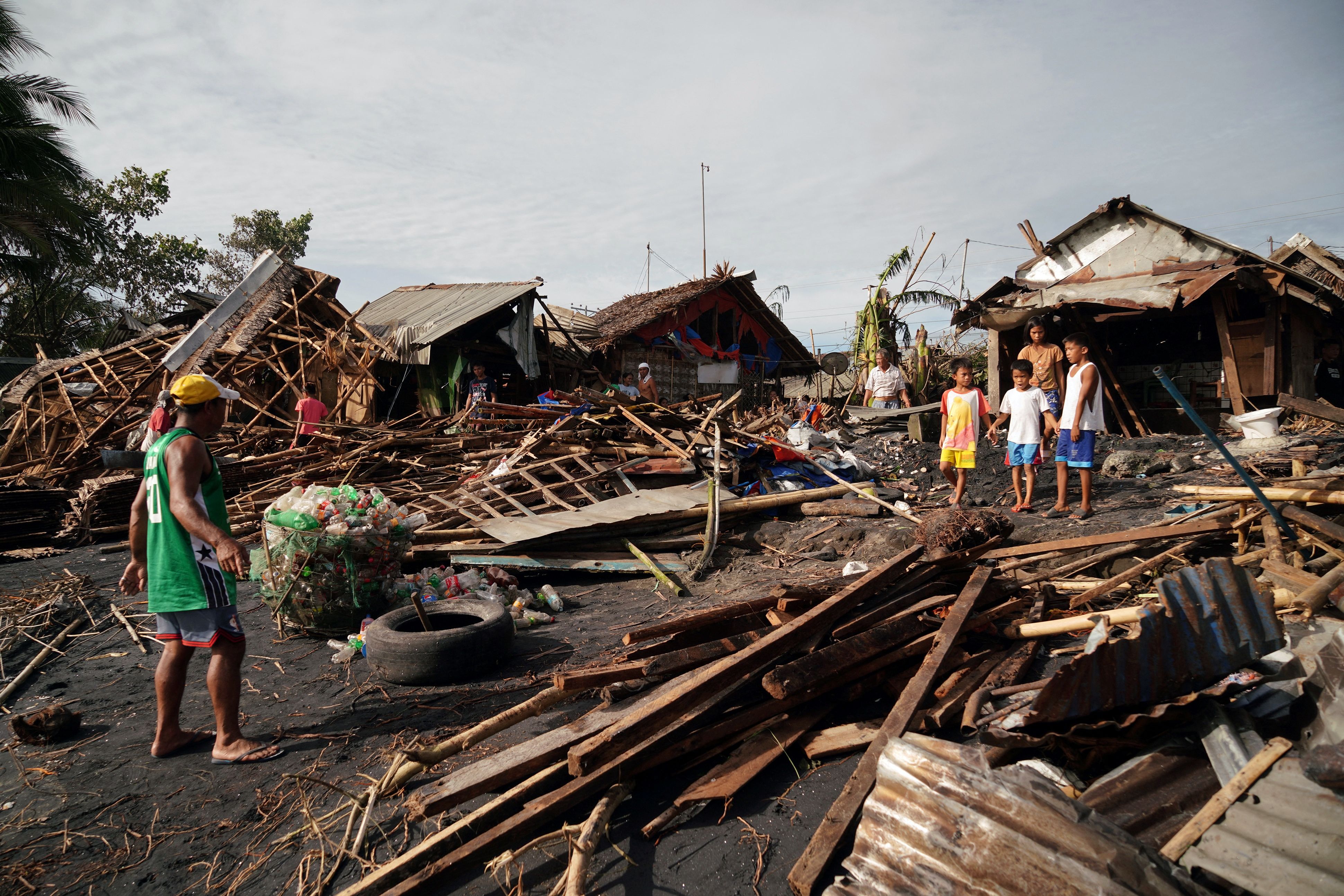 Residents salvage belongings from their destroyed homes in the coastal town of Dulag in Leyte province on December 17, 2021, a day after Super Typhoon Rai hit.